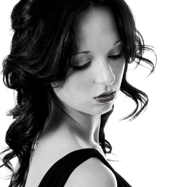 black and white moody portrait model gazing down over shoulder by photographer in Fife