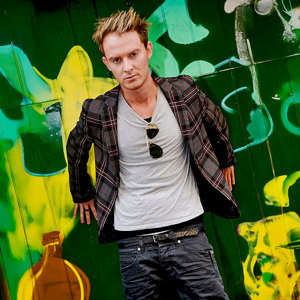 man standing by graffiti wall fashion photography in Fife