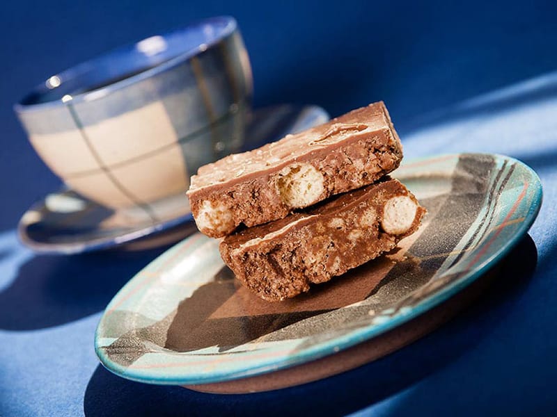 cake and coffee cup beautifully lit on blue background commercial and promotional photographer in Fife