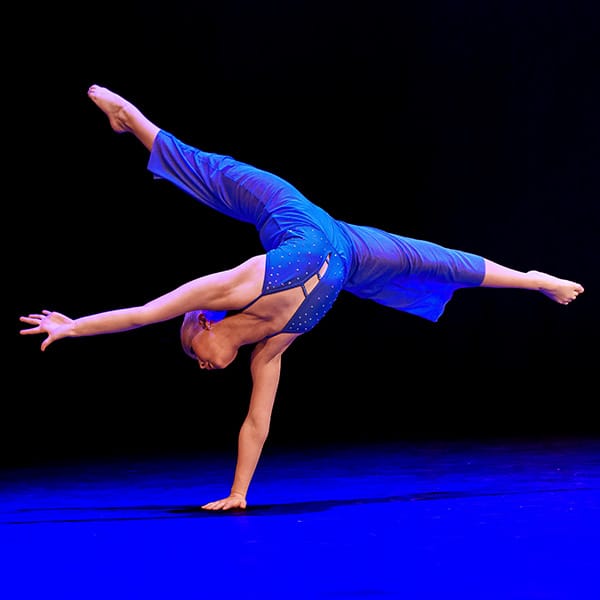 dancer in blue costume balancing on one hand by dance photographer in Fife