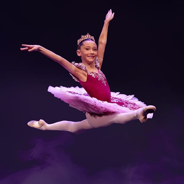 young dancer split jump in ornate tutu by dance photographer in Fife
