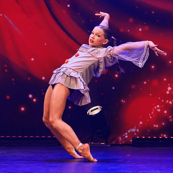 dancer in competition clown costume balances on toes by dance photographer in Fife