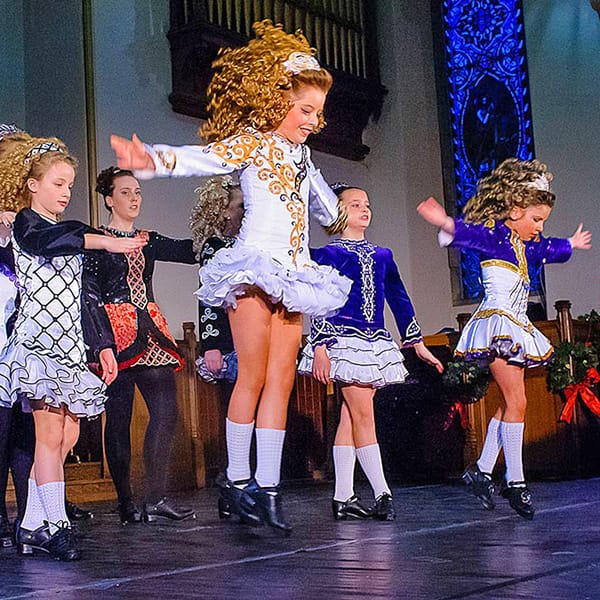 Irish dancers perform in church by dance photographer in Fife